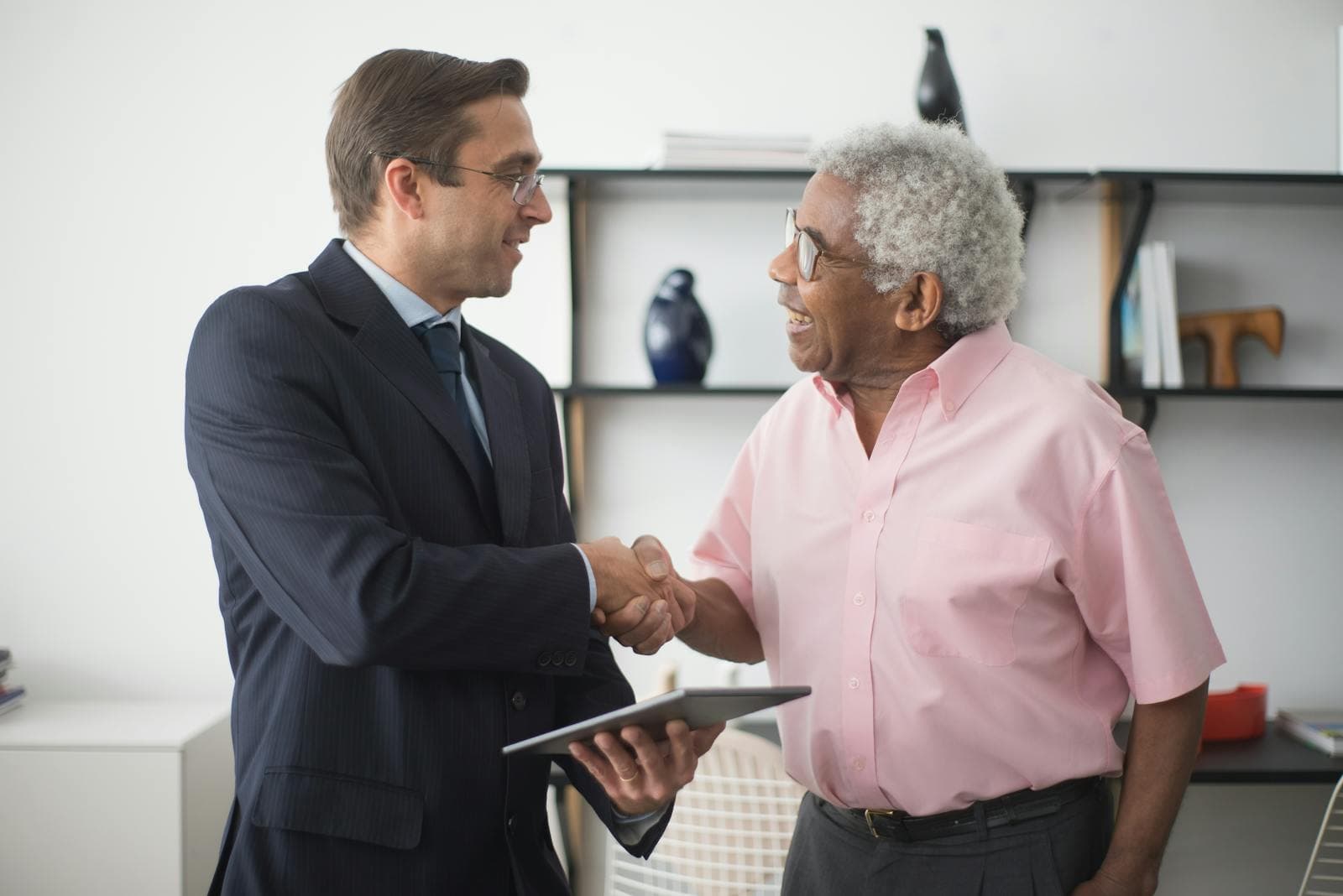A handshake during a professional meeting — symbol of a transparent senior care agreement.